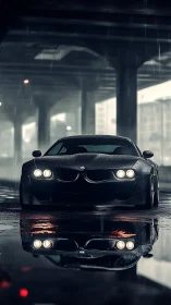 Dark BMW sports car under city bridge in heavy rain.