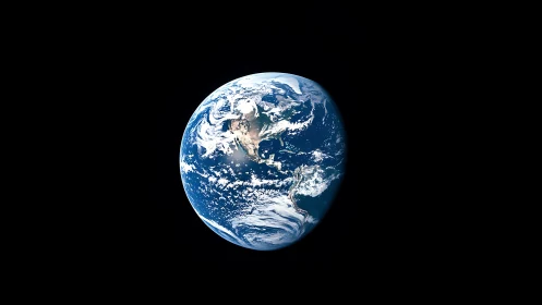 Earth from deep space with illuminated oceans and clouds.