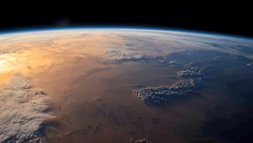 Orbital sunrise across Earth&rsquo;s limb with atmospheric gradient.