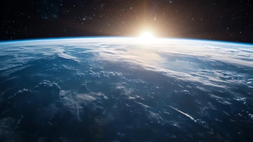 Orbital sunrise over Earth&rsquo;s glowing blue horizon.
