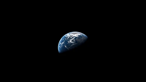 Earth partially illuminated against deep black space field.