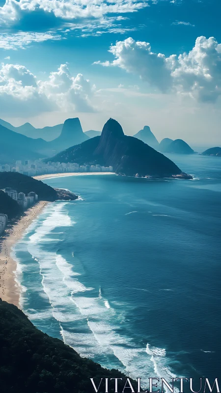 Sunlit Brazilian coast curves beneath misty blue mountains