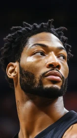 Courtside gaze of a focused baller under arena lights.