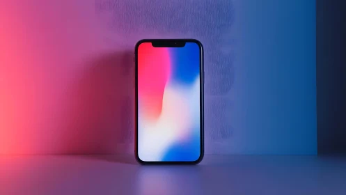 Modern smartphone standing upright with colorful gradient lighting.
