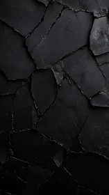 Shattered matte black surface with fractured stone geometry.