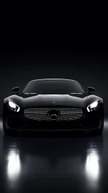 Frontally lit black sports coup&eacute; under high-contrast studio lighting