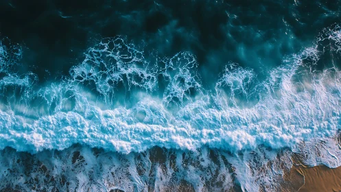 Breaking turquoise waves surge over a sunlit sandy shore.