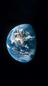 Earth is partially illuminated against a dark space background