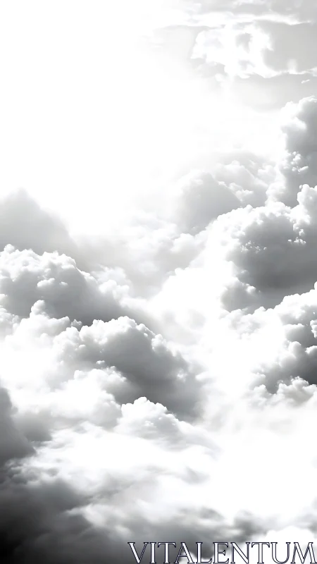 Sunlit cumulus clouds dissolve into bright white sky