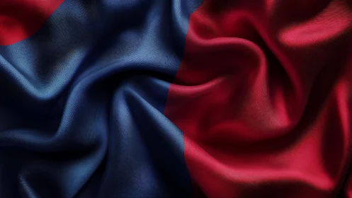 Folded red and blue satin fabric with central seam.