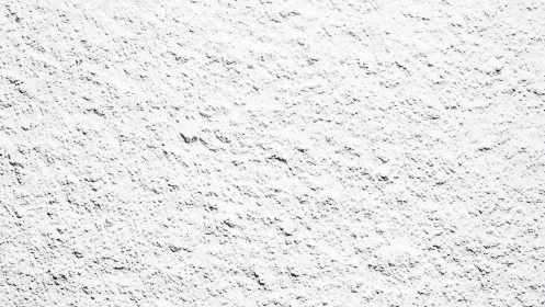 Granular snowy texture over rough ground surface pattern.