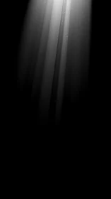 Monochrome light beams cutting through dark void space.