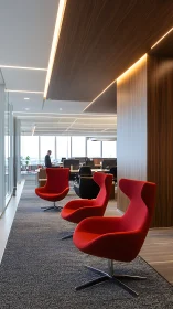 Modern office seating zone with red lounge chairs arrangement.