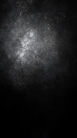 Dark scratched textured background with central light focus