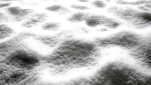 Granular snow surface under high-contrast directional backlight