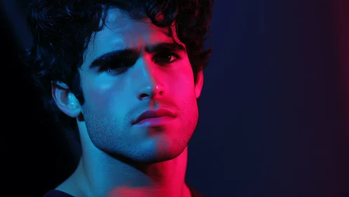 Neon-shadowed portrait cuts a brooding face through twilight glow.