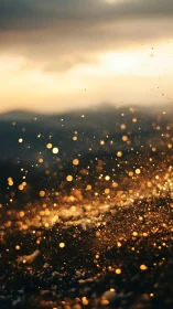 Golden particles drifting over dark textured landscape.