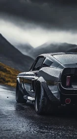 Classic muscle car resting on a rain soaked mountain road.