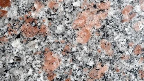 Close-up of Pink Granite Surface with Natural Speckled Texture.