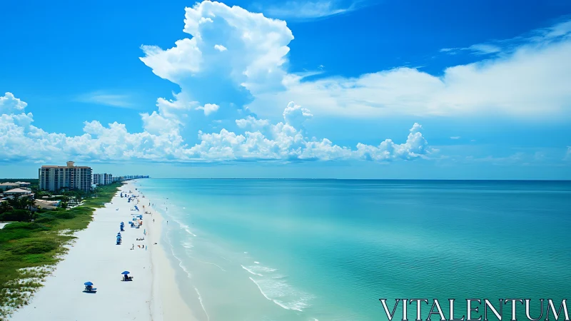 Azure shoreline drifting into infinity beneath sculpted clouds.