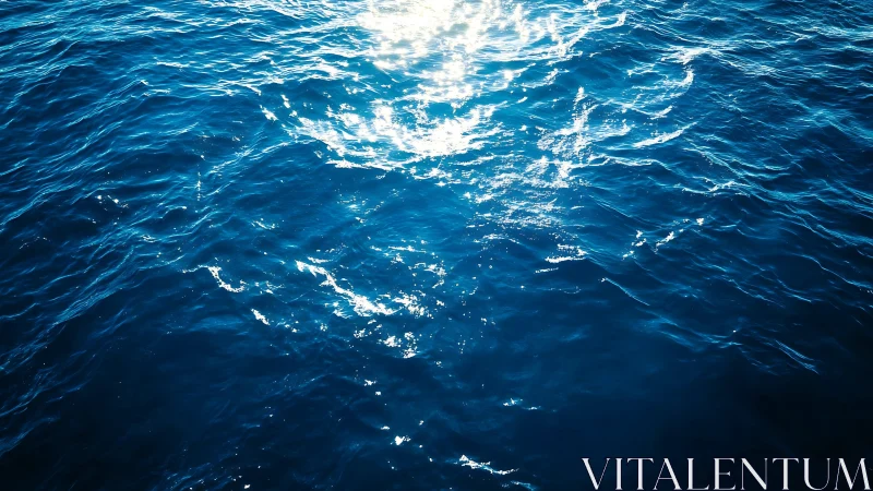 Sunlight reflects on deep blue ocean surface with small waves