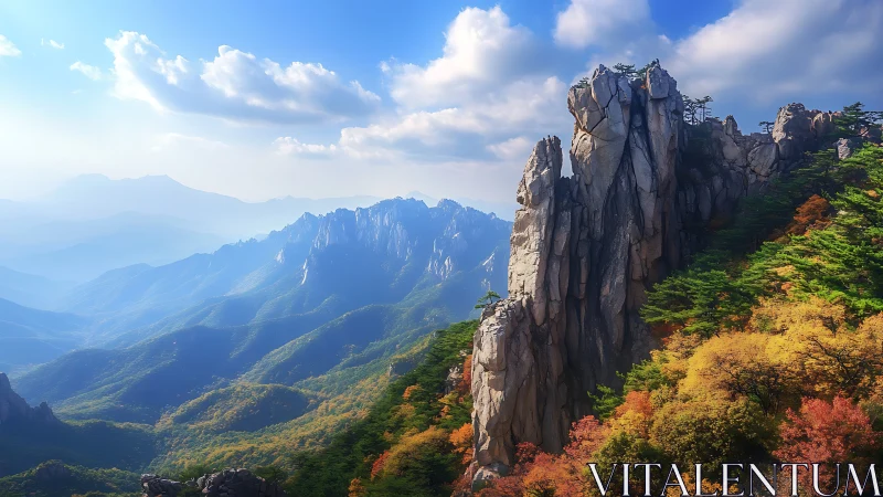 Towering cliffs rise above misty autumn mountain valley.
