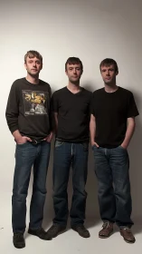 Studio portrait of three similar men in casual denim wear.