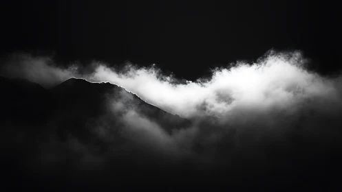 Quiet mountain ridge glows softly through drifting clouds