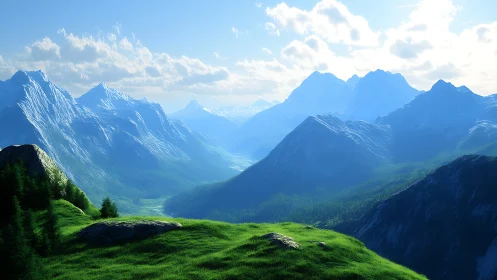 Snowy mountain range overlooks sunlit grassy valley