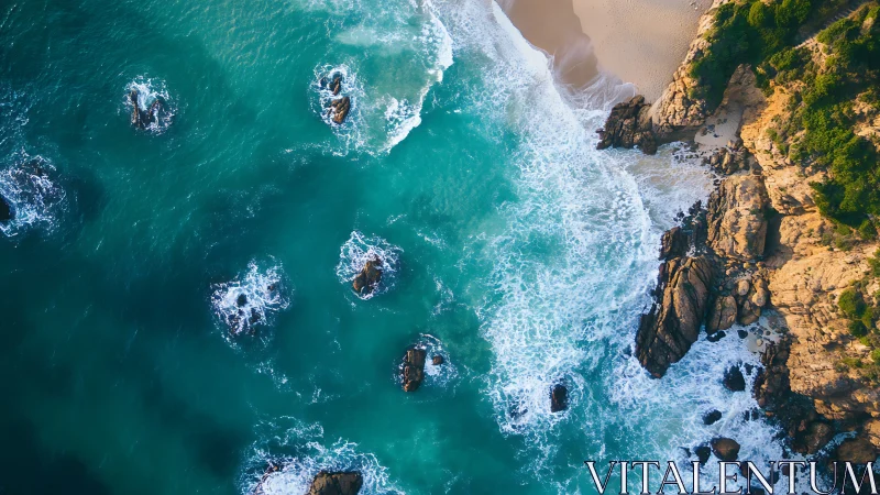 Turquoise surf breaks along rugged golden coastal cliffs.