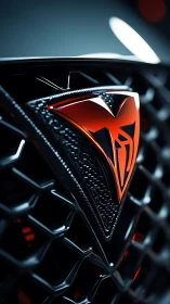 Glossy red car emblem glows against a dark geometric grille