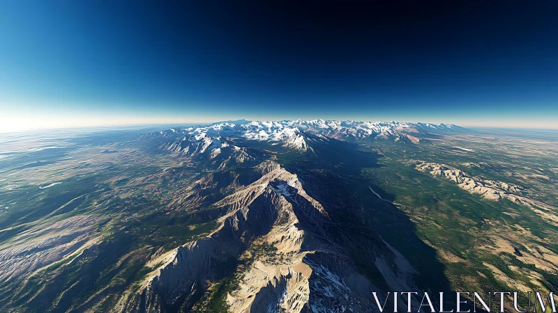 High altitude view reveals sweeping snowcapped mountain range