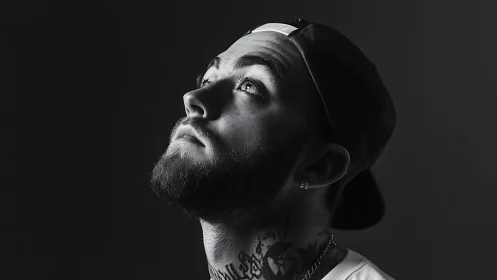 Monochrome side-lit male portrait in dramatic studio profile.