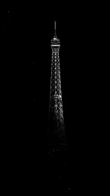 Eiffel Tower silhouette cuts stark profile against night sky.