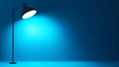 Minimal floor lamp casting vivid blue studio glow.