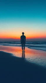 Silhouetted figure on shoreline at gradient sunset horizon.
