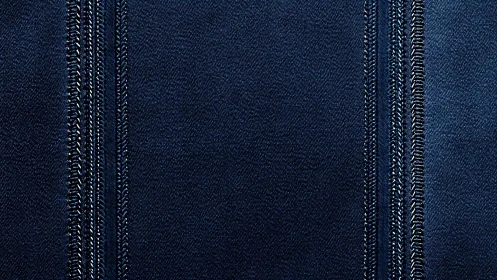 Dark blue denim fabric with parallel stitched seams pattern.