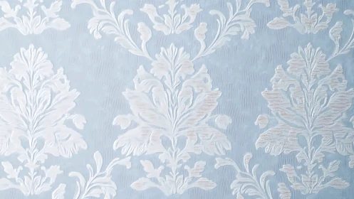 Light blue damask wallpaper with white floral ornament pattern.