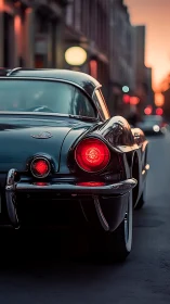 Classic black coupe glows under soft urban dusk light.