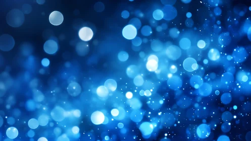 Abstract blue bokeh lights background with glowing orbs effect.