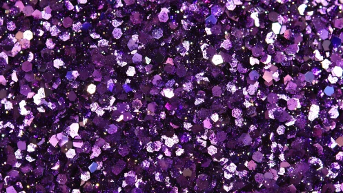 Close-up view of dense sparkling purple glitter texture.