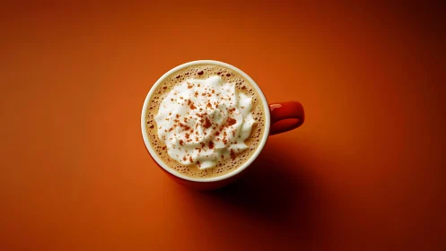 Cinnamon crowned latte swirling on fiery autumn backdrop.
