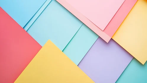 Geometric layout of overlapping pastel paper sheets in flat lay