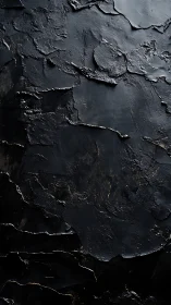 Textured black abstract surface with cracked glossy layers.