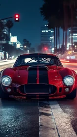 Red racing coupe waits under city traffic light at night