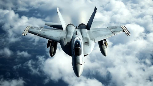 Military jet aircraft flies above dense cloud layer in daylight