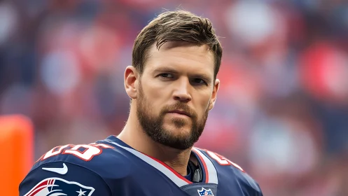 Focused football player sharing a calm, confident gaze.