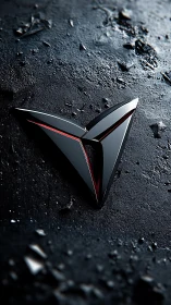 Sleek metallic triangle emblem on rugged dark ground.