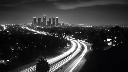 Night freeway curves toward illuminated downtown skyline