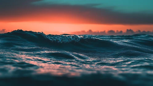 Crimson horizon over teal ocean swells at golden dusk.